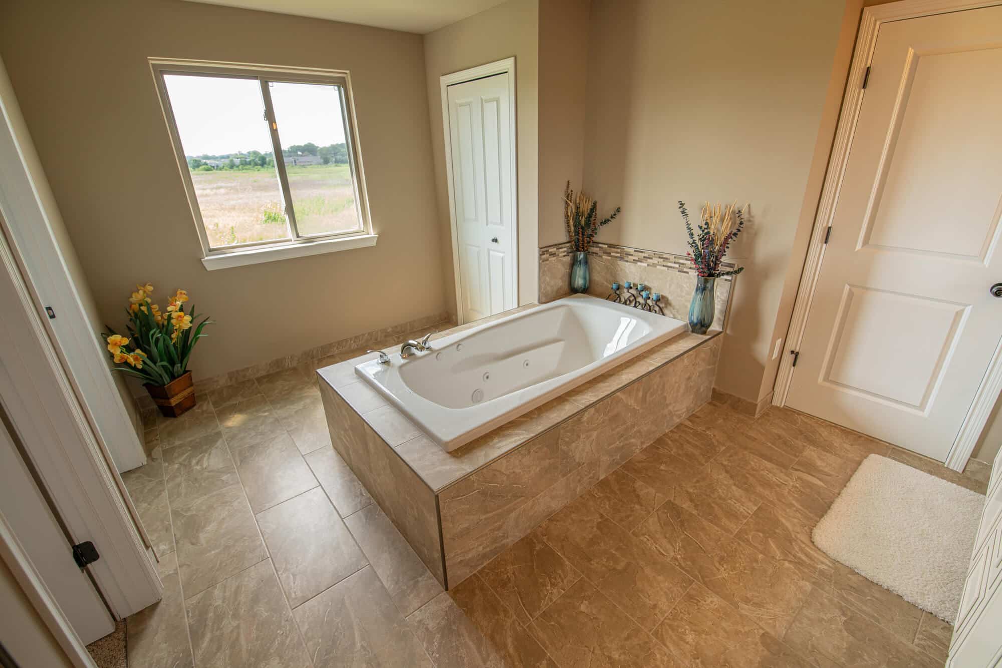 A large bathroom with a tub and a sink