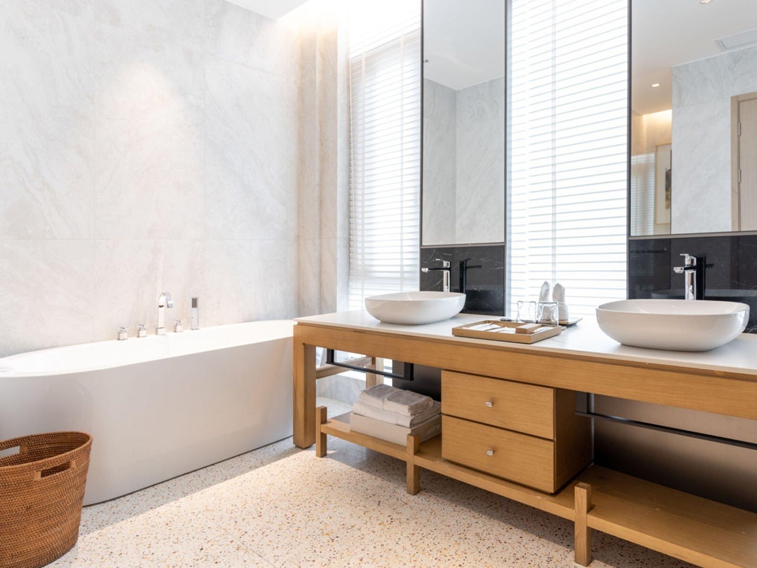 Modern bathroom with freestanding bathtub and wood vanity