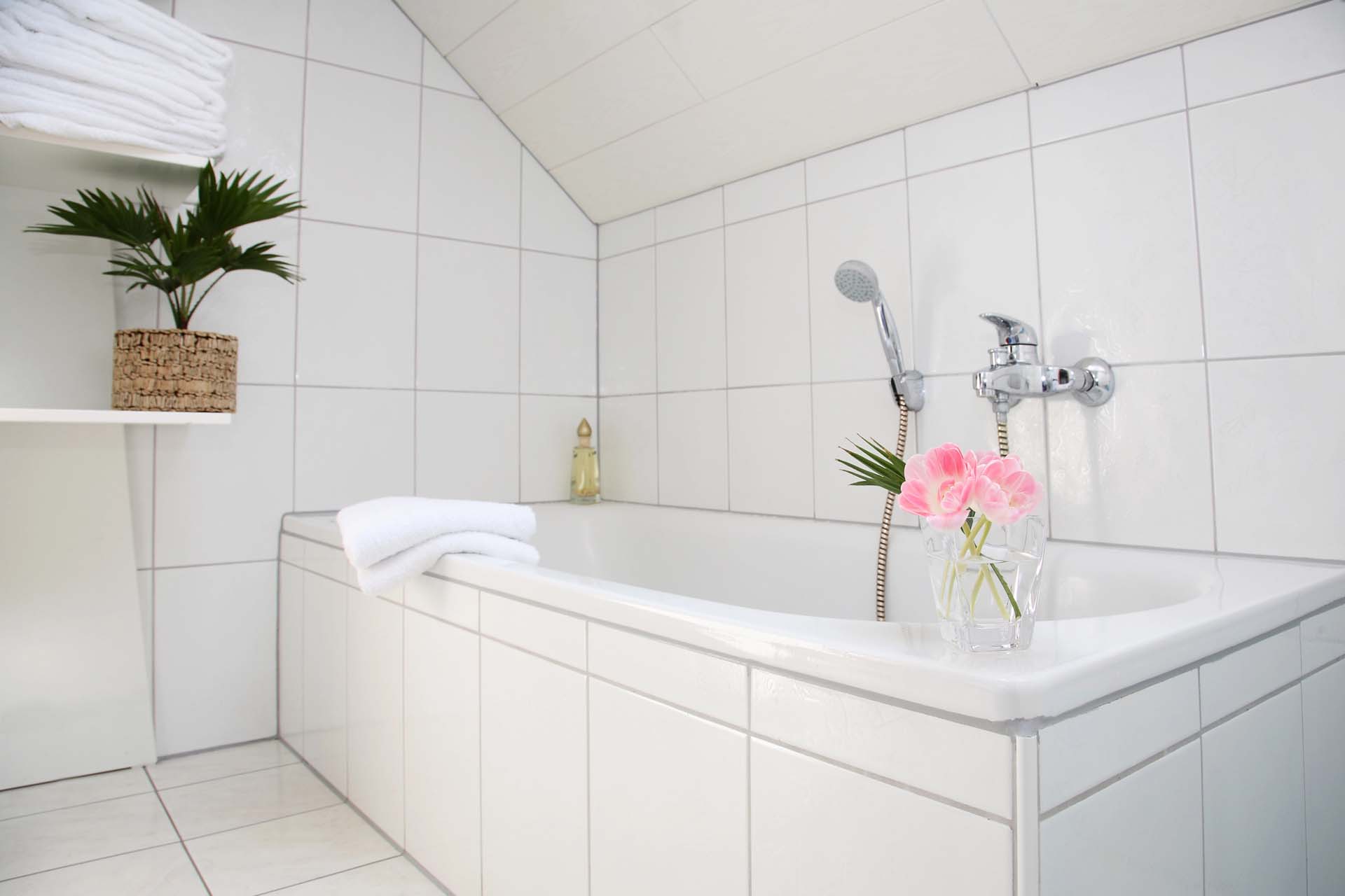 Bright white bathroom with a modern bathtub